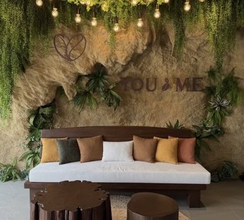 Plant wall and cushioned lounge corner